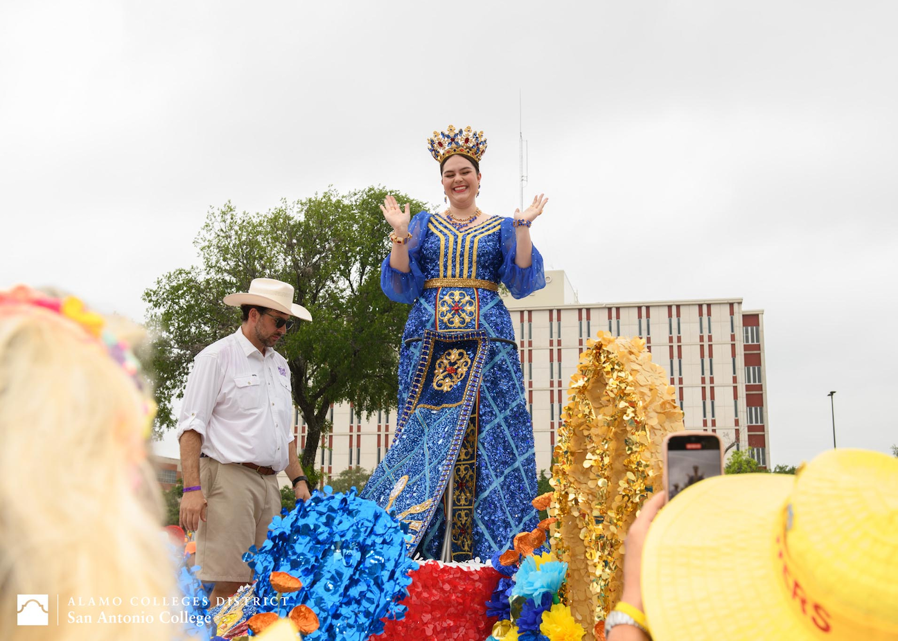 Young woman posing in blue gown with crown on head