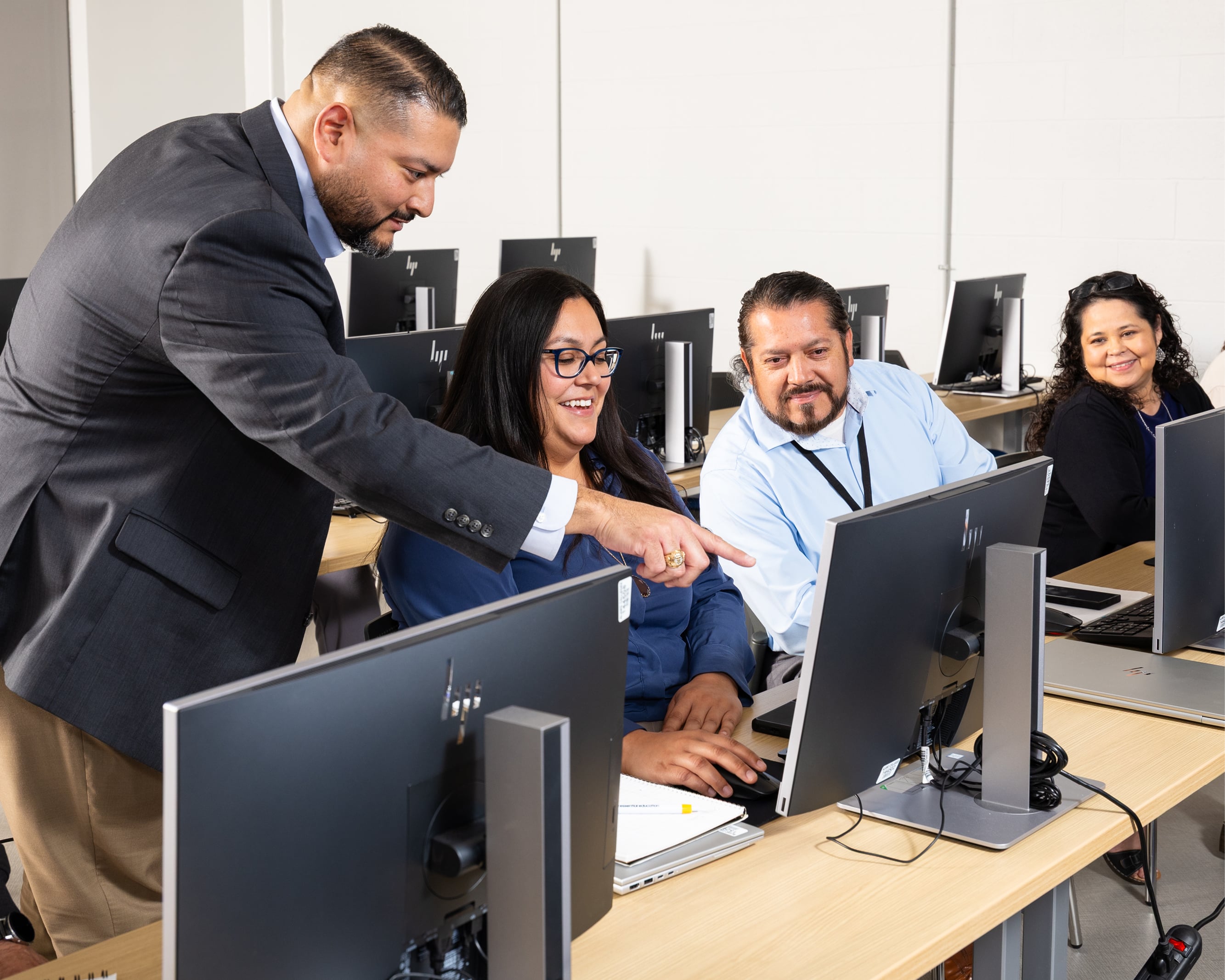 Instructor helping students in computer lab