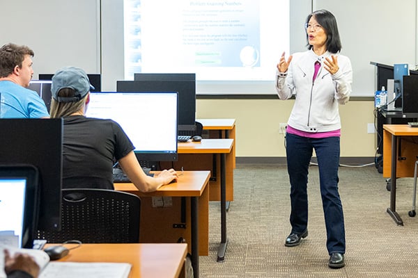 Female teacher speaking in front of class