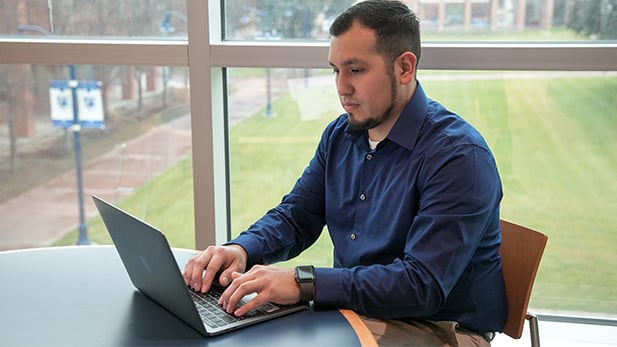 Male Student on his Laptop Male Student on his Laptop