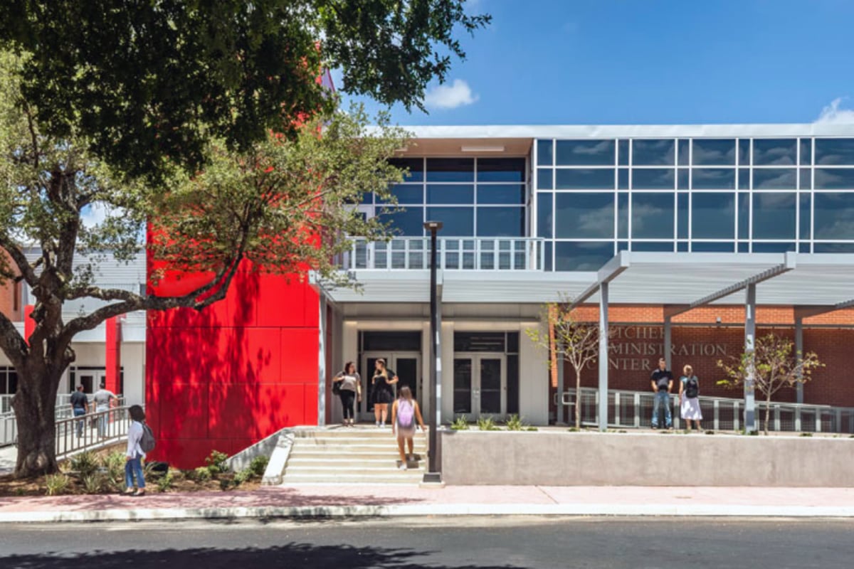 Photo of the front of the Fletcher Administration Building with students walking in and out.