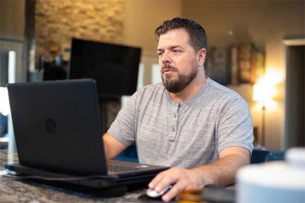 Alamo Colleges Online Student studying off of laptop