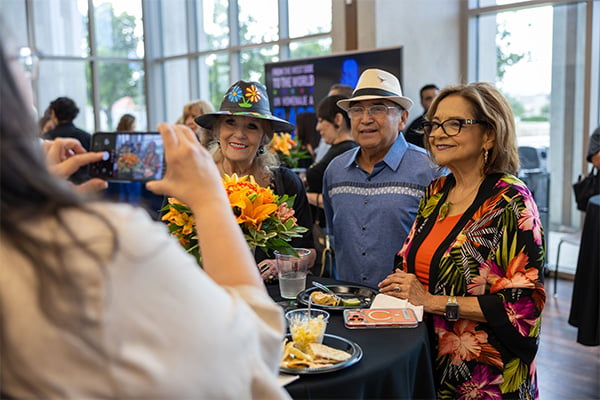 Members of the crowd pose for photos including Trustee Dr. Yvonne Katz and former Vice Chancellor for Academic Success Dr. Adelina Silva
